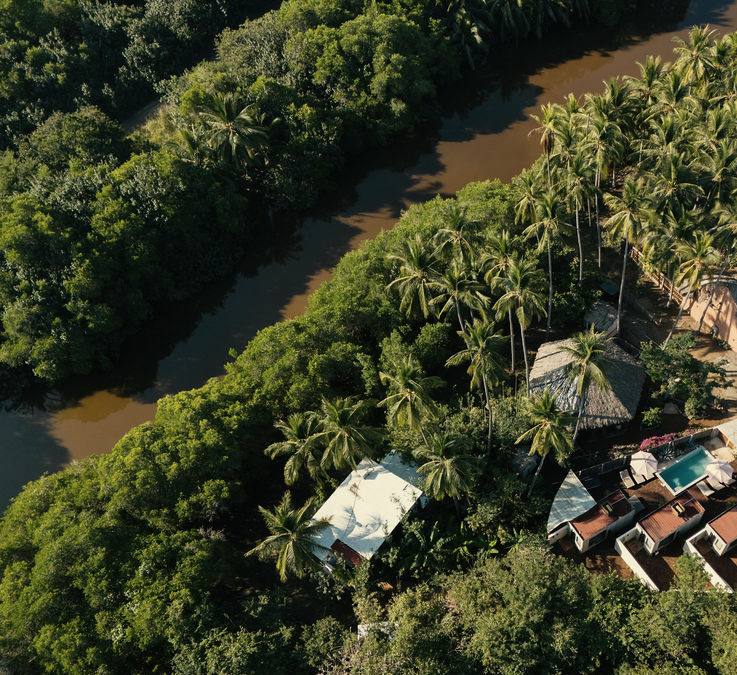 Aerial view of Templo Saladita on the lagoon — pool, casitas, treehouse, yoga shala
