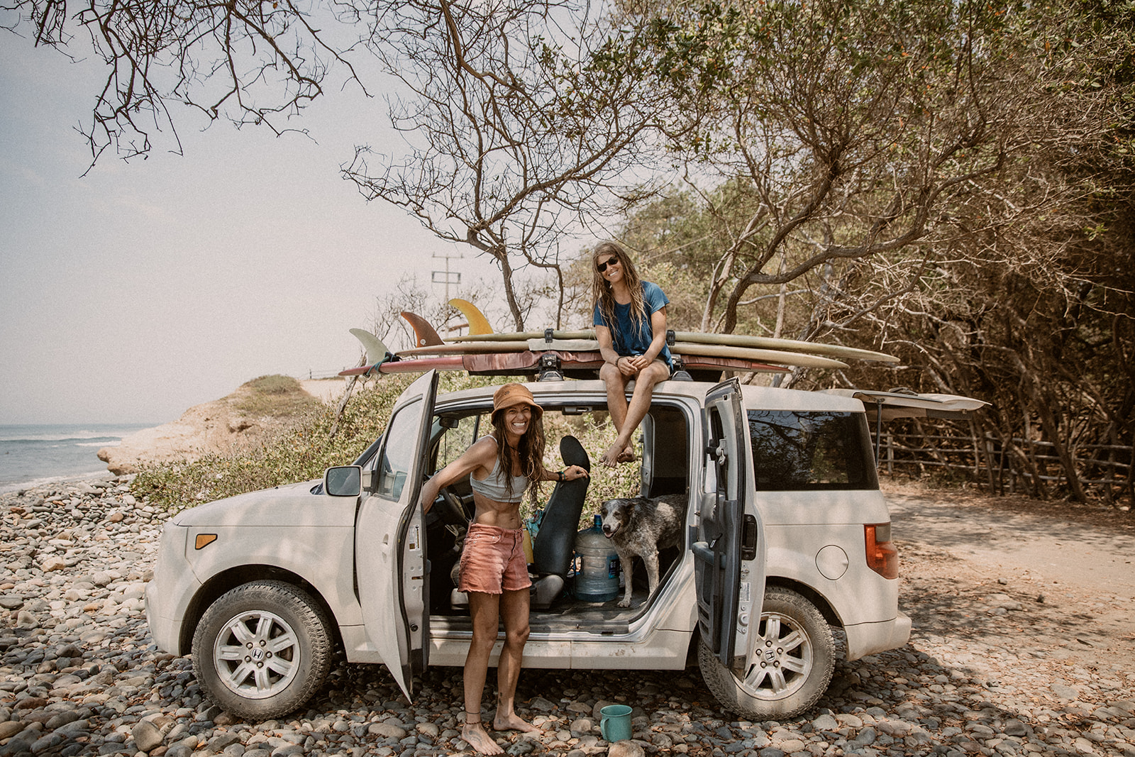 Addie Conner and Jordan Smith with surfboards on the way to La Saladita