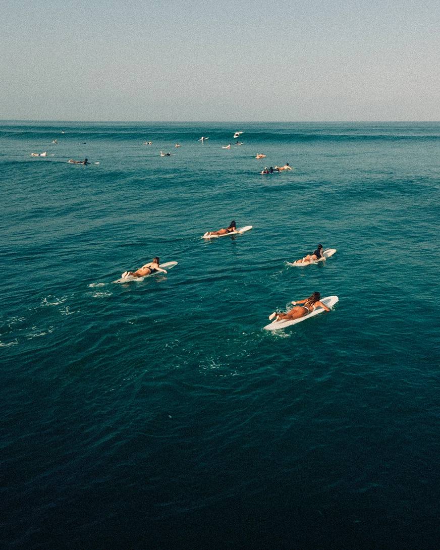 Surfers paddling out at La Saladita